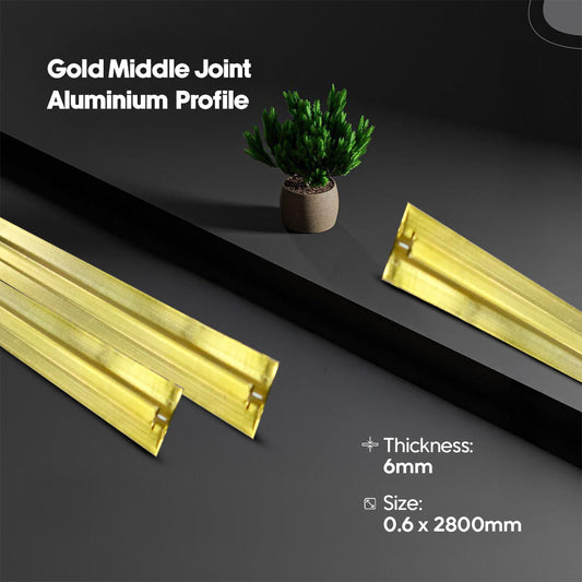 Gold middle joint aluminium profile on a dark surface with a plant in the background